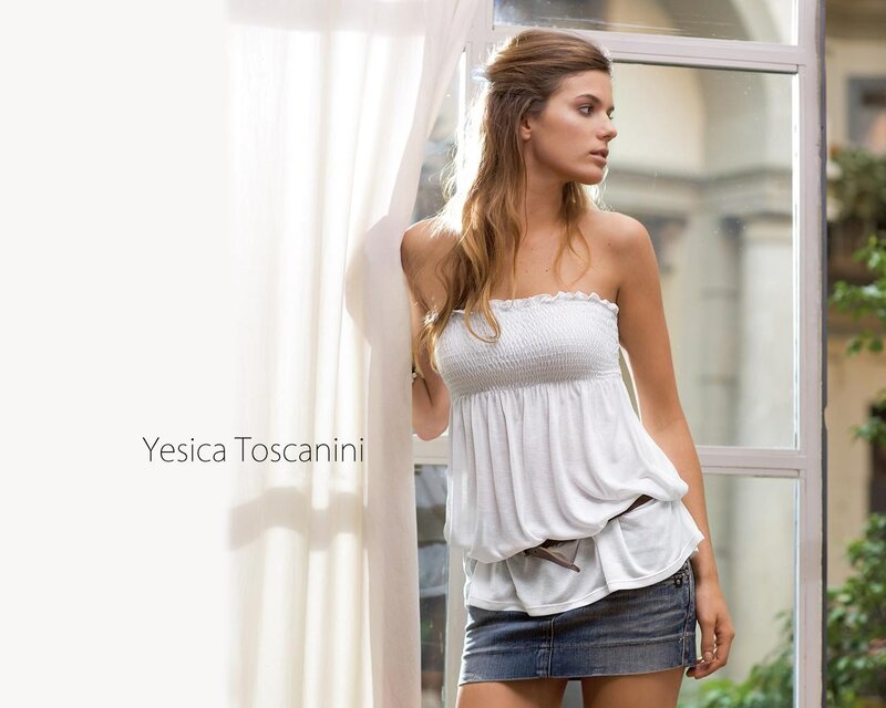 Woman in white top by window