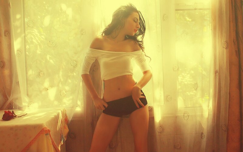 woman in white top by window