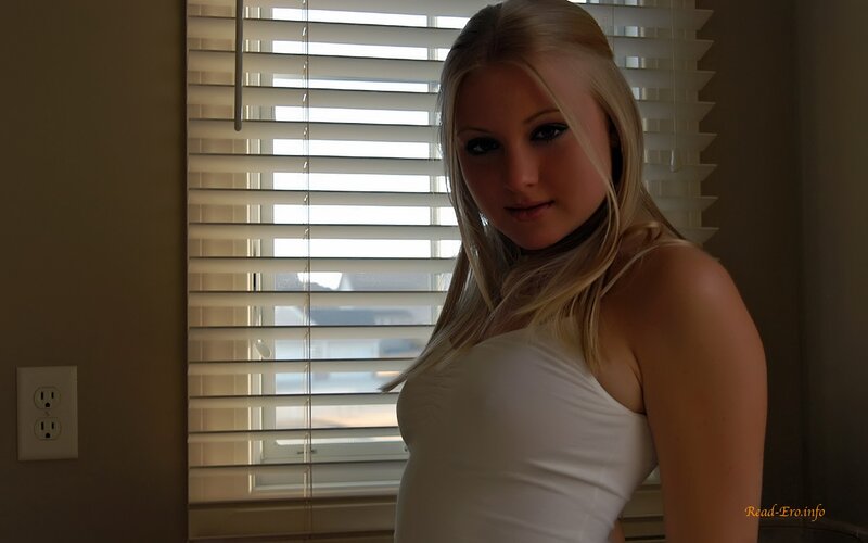 woman in white top by window