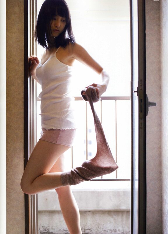 woman in white top by window