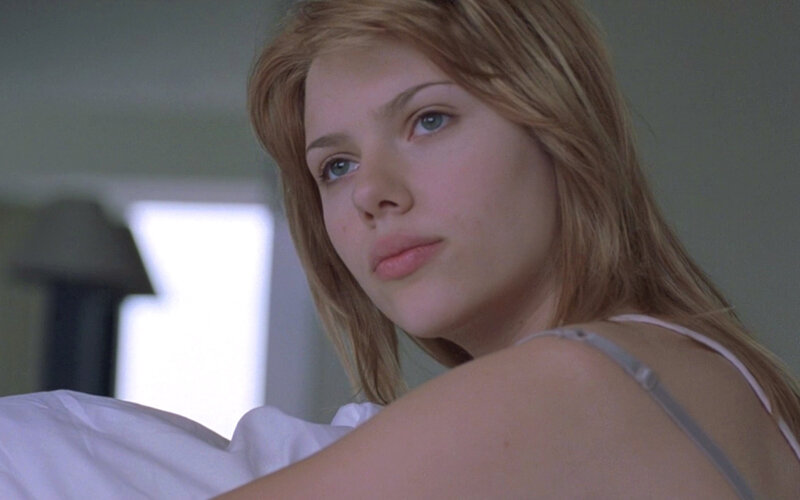 woman in white top looking at camera