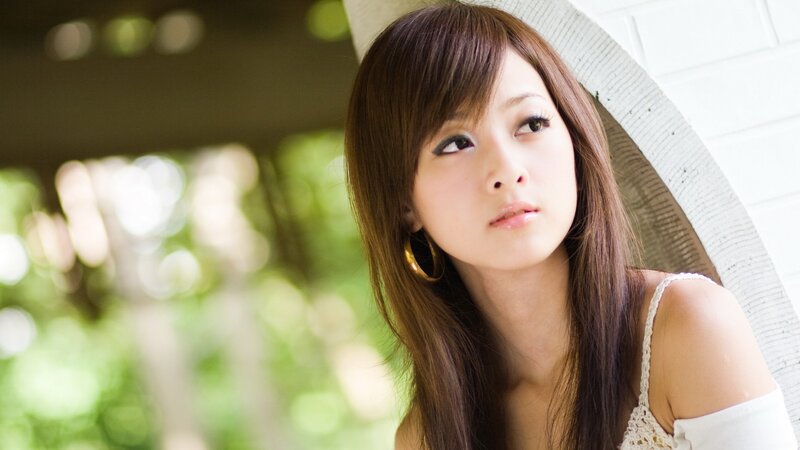woman in white top looking away