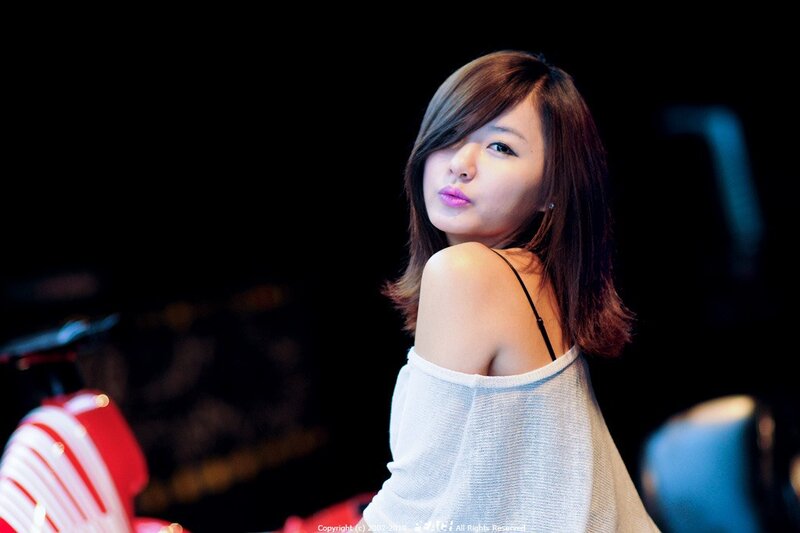 woman in white top looking back