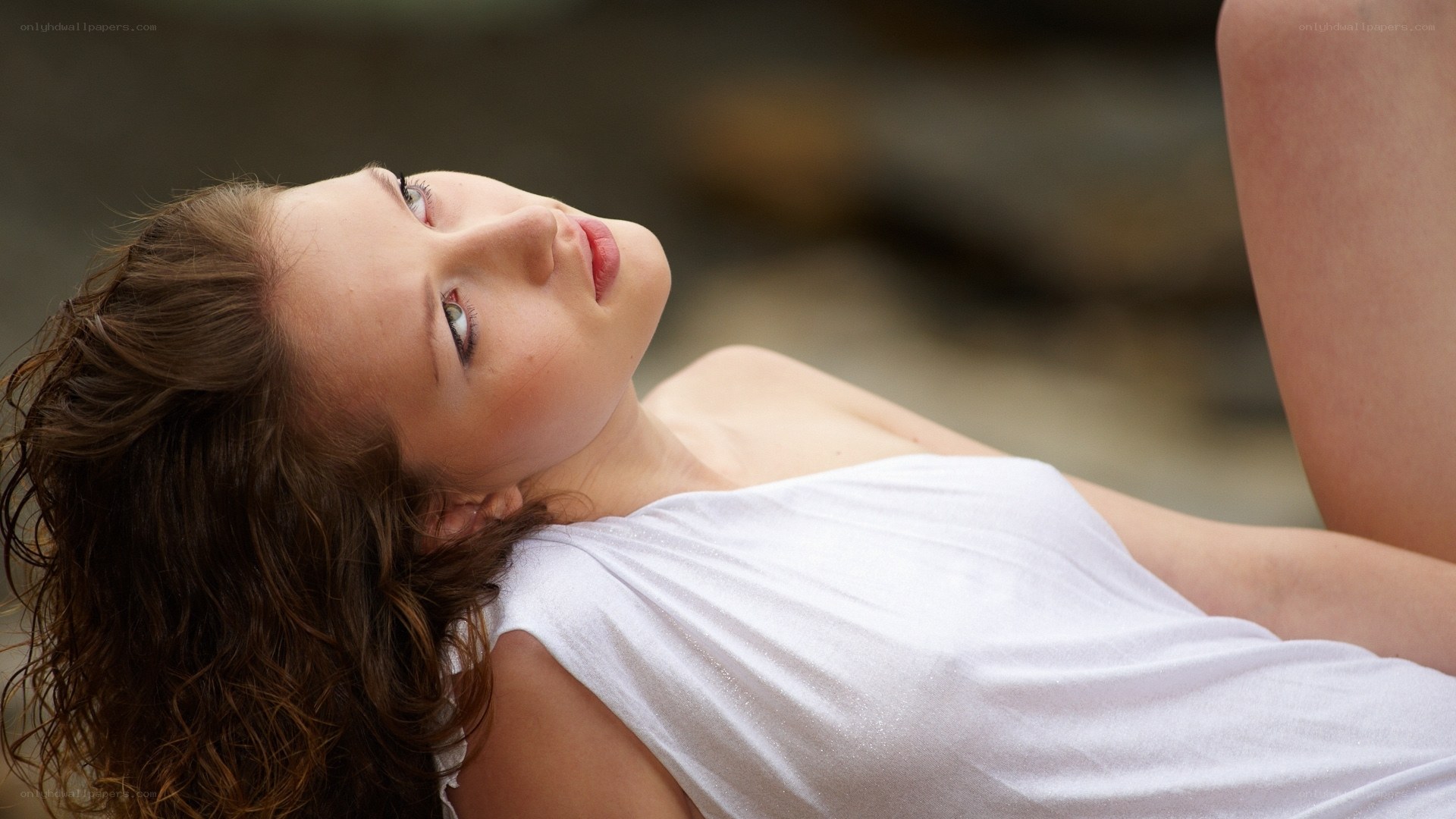 woman in white top lying down