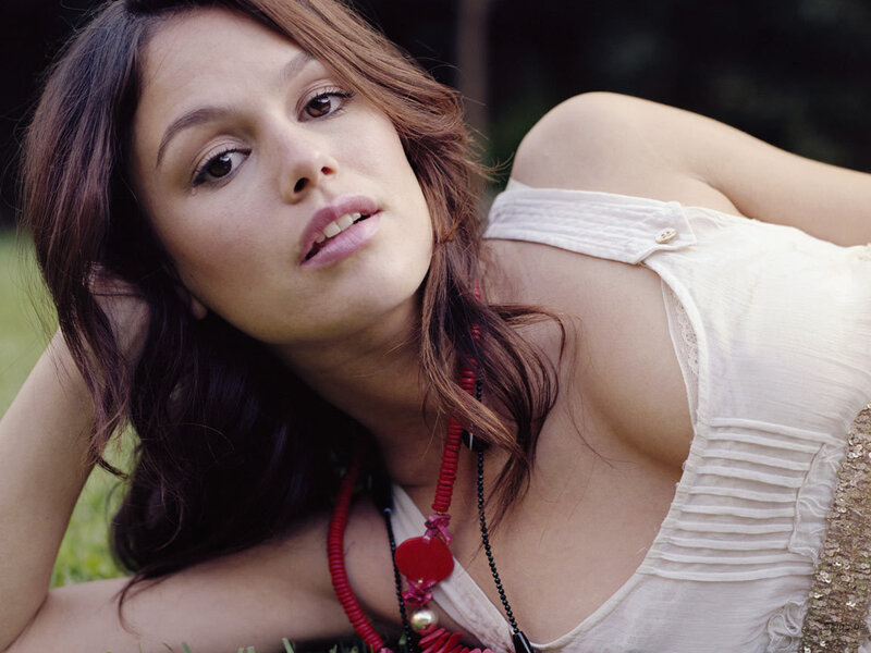 woman in white top lying on grass