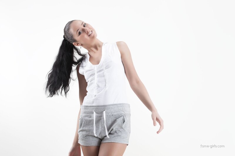 Woman in White Top — Neutral, Photograph, White Background, Long Hair, Shorts