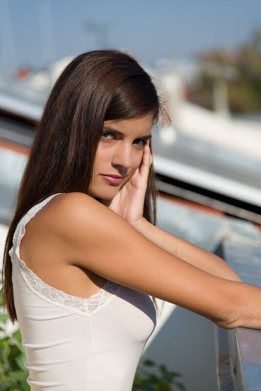 woman in white top on balcony
