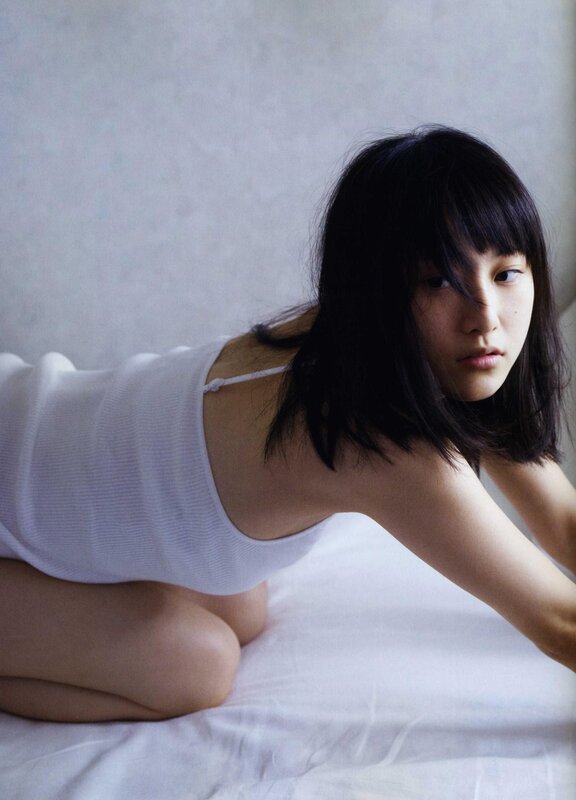 woman in white top on bed