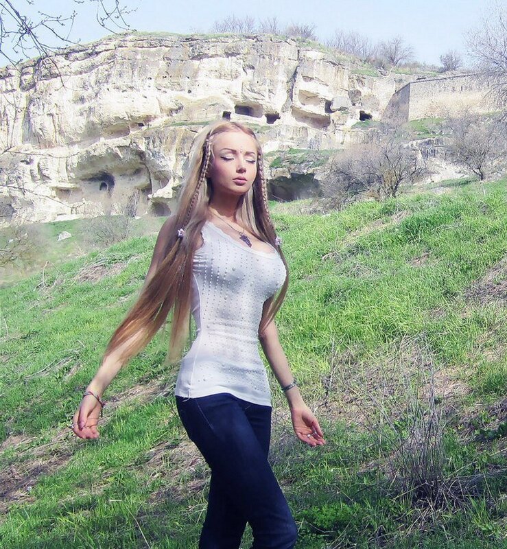 Woman in white top on grassy hill
