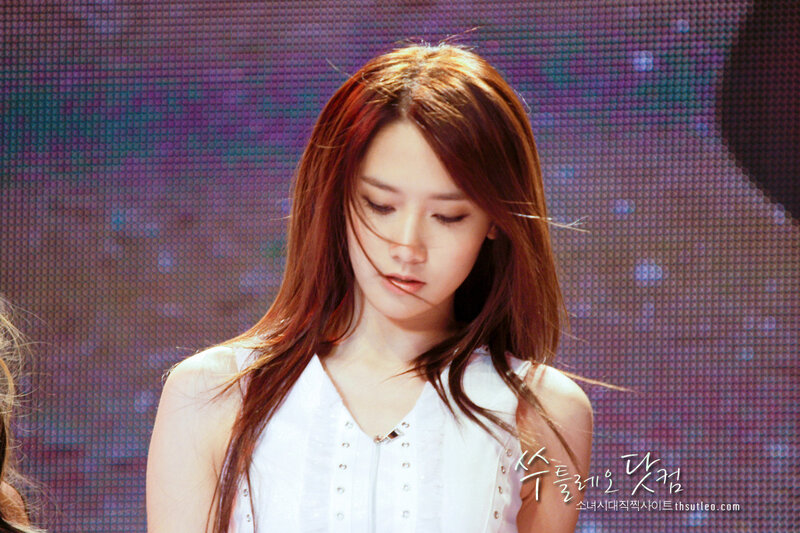 woman in white top on stage