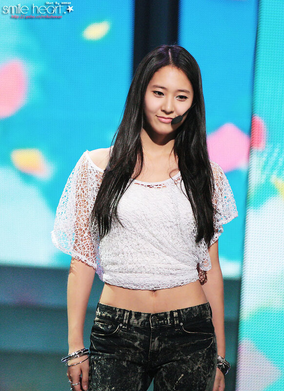 woman in white top on stage