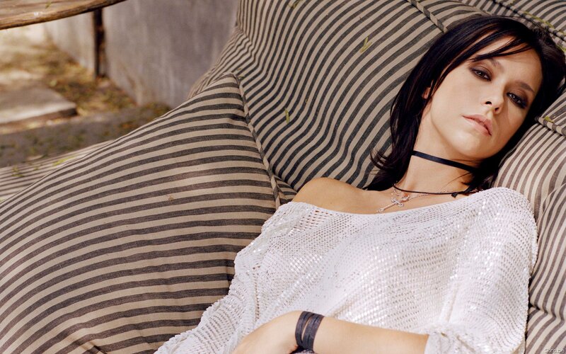 woman in white top on striped couch