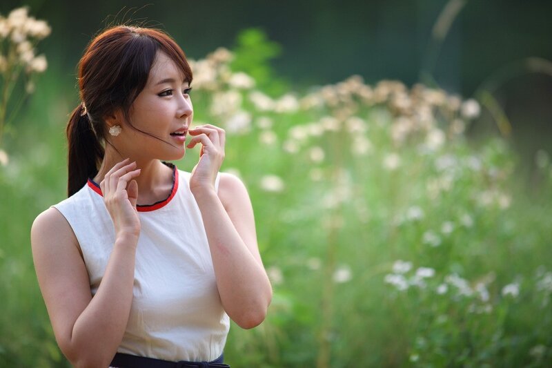 woman in white top outdoors