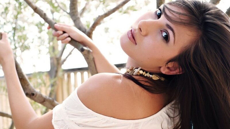 woman in white top outdoors