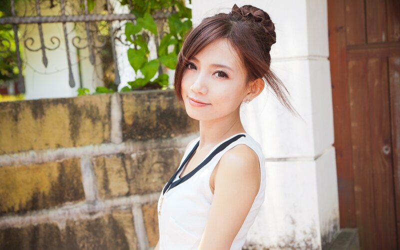 woman in white top outdoors