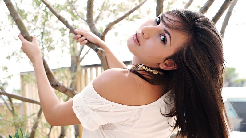 woman in white top outdoors