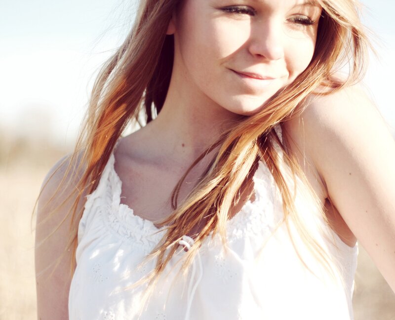 woman in white top outdoors