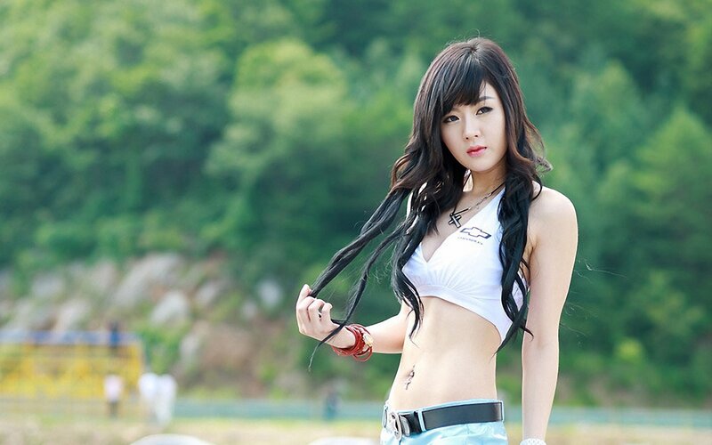 woman in white top outdoors