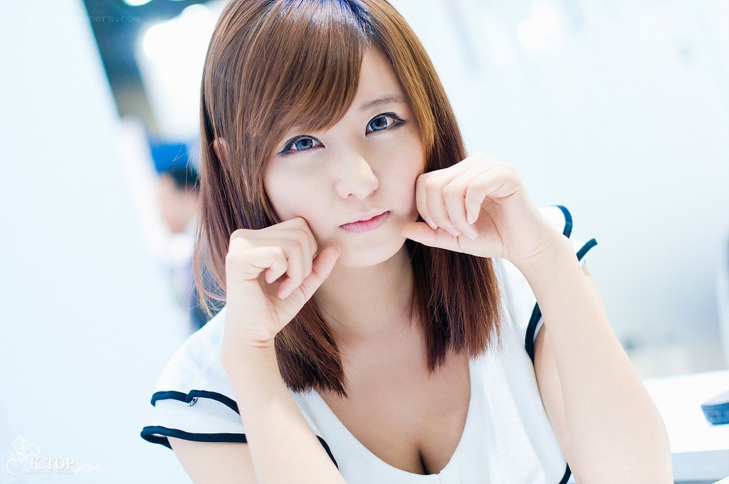 woman in white top posing