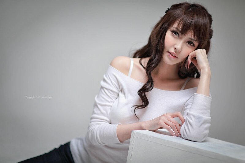woman in white top posing