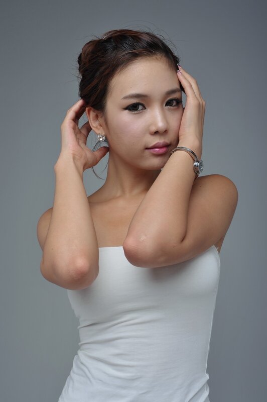 woman in white top posing