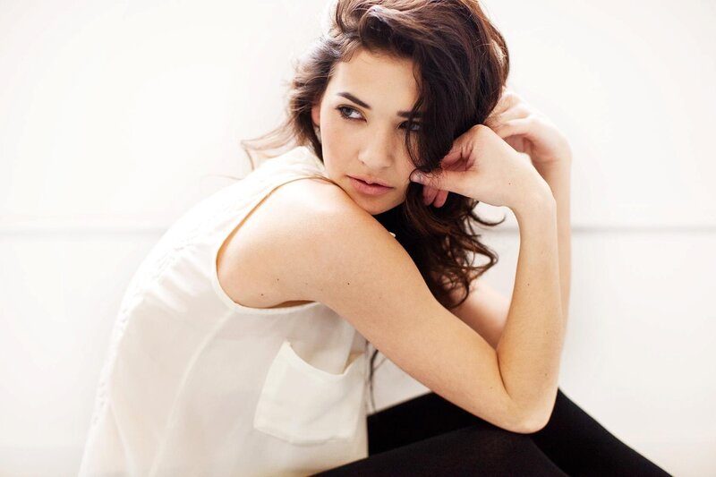 woman in white top posing