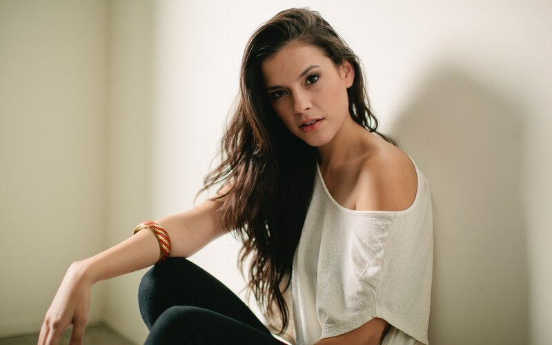woman in white top sitting