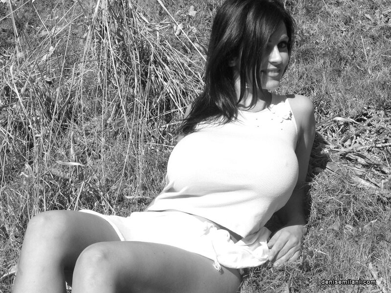 Woman in white top sitting on grass