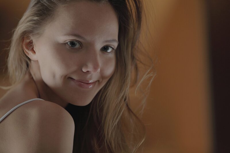 woman in white top smiling