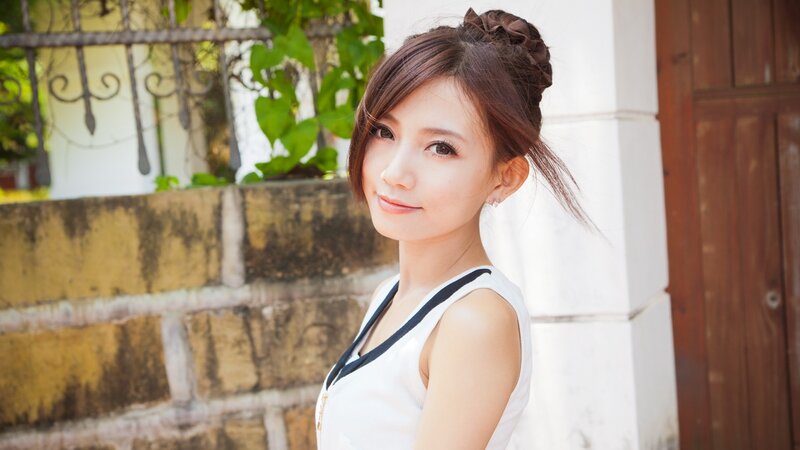 woman in white top smiling