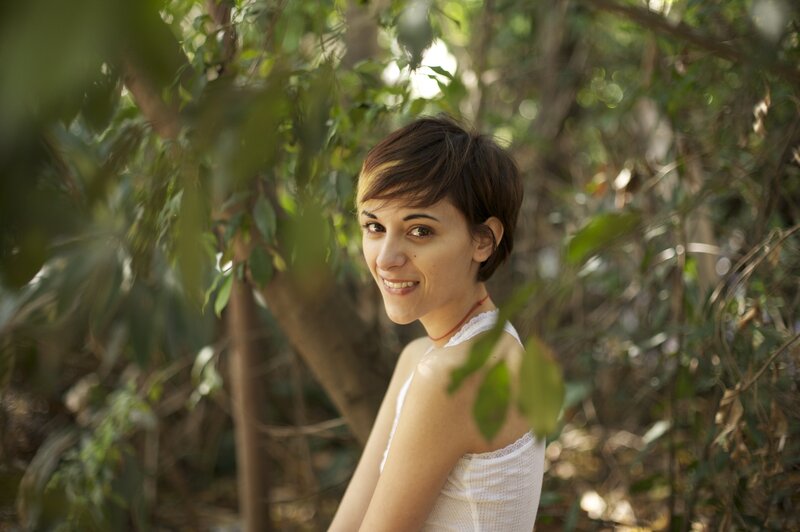 woman in white top smiling