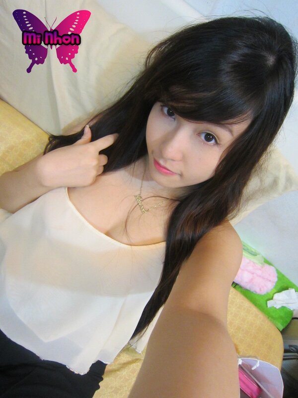 woman in white top taking selfie