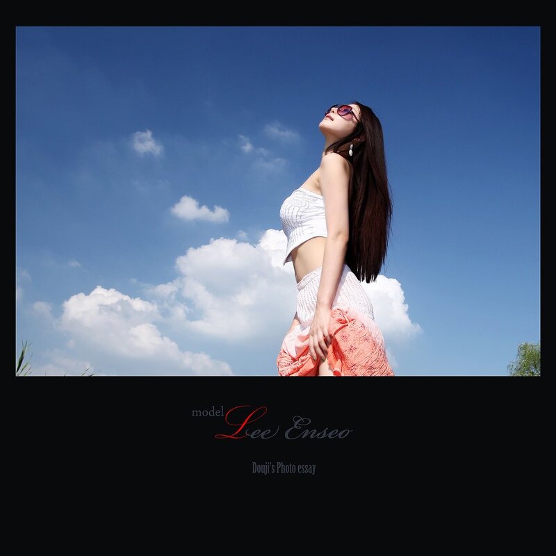 Woman in white top under blue sky