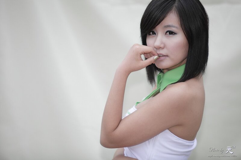 woman in white top with green collar