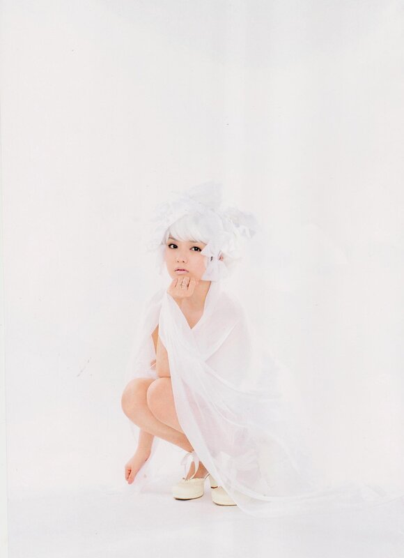 woman in white veil crouching