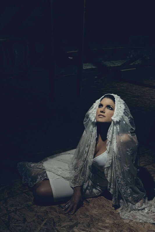 woman in white veil kneeling