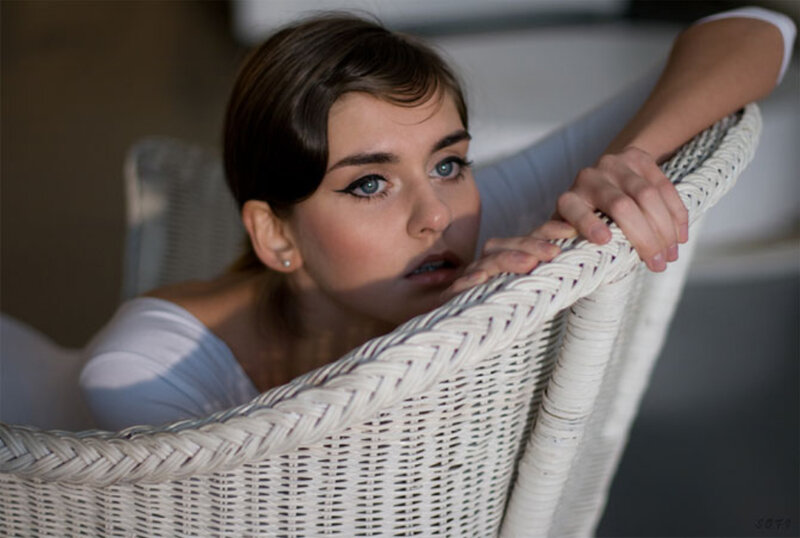 woman in white wicker chair