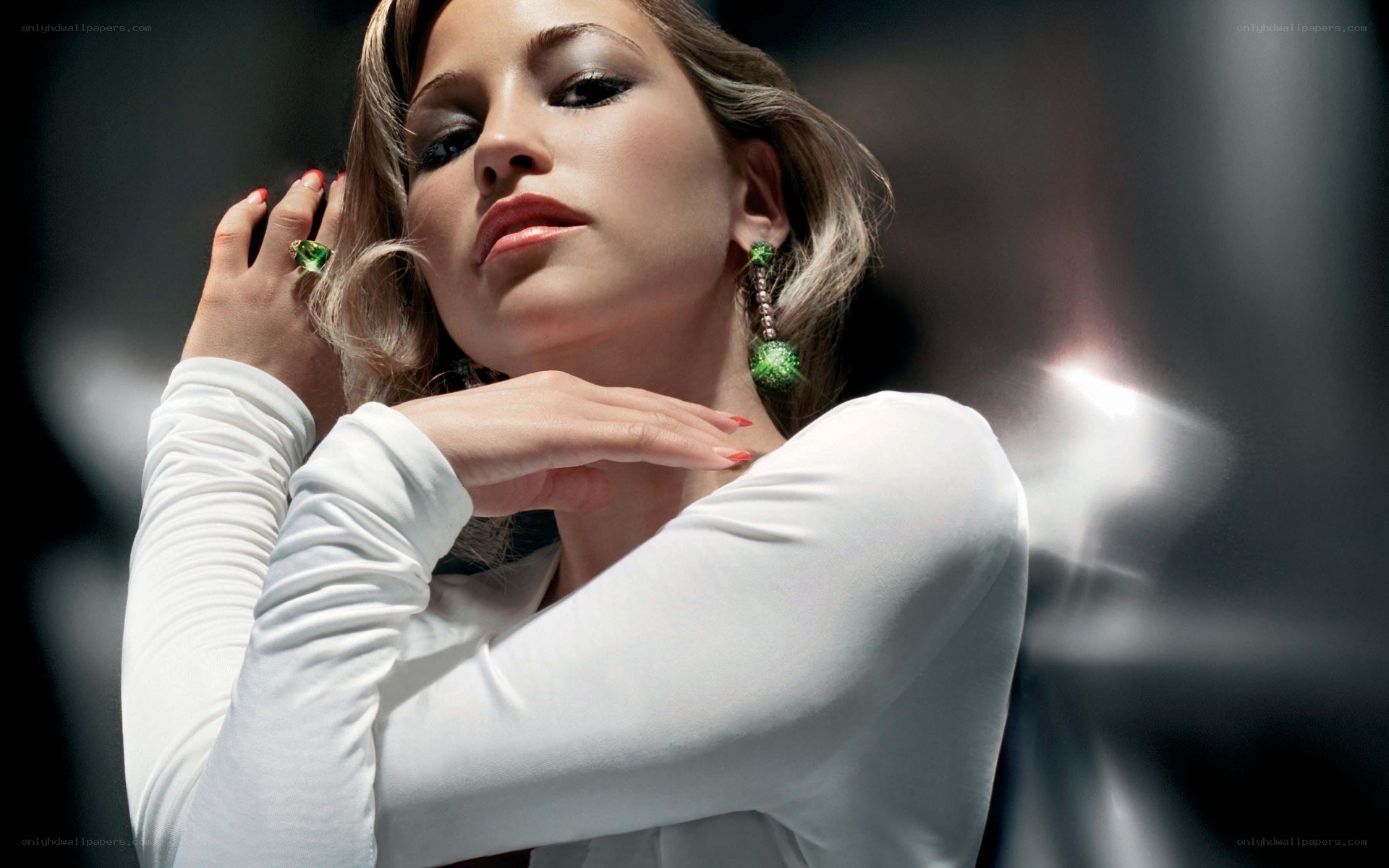 woman in white with green jewelry