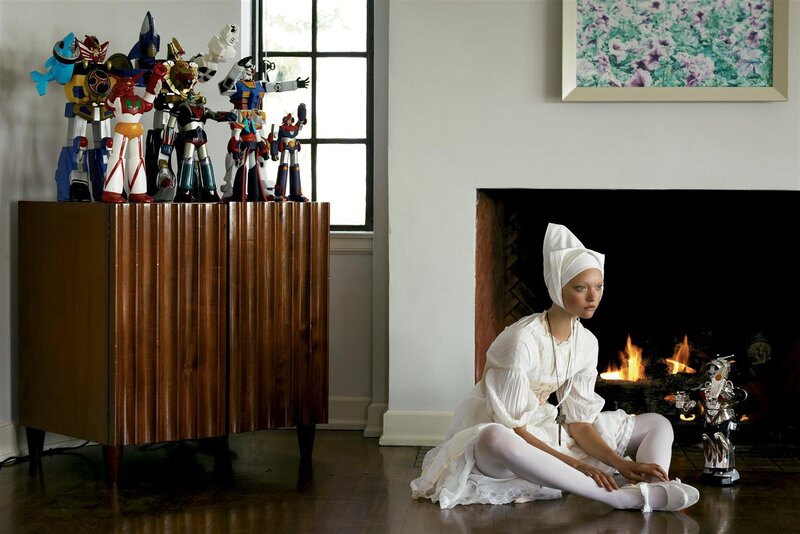 Woman in white with robot toys