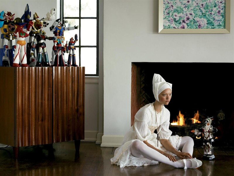 Woman in white with robot toys