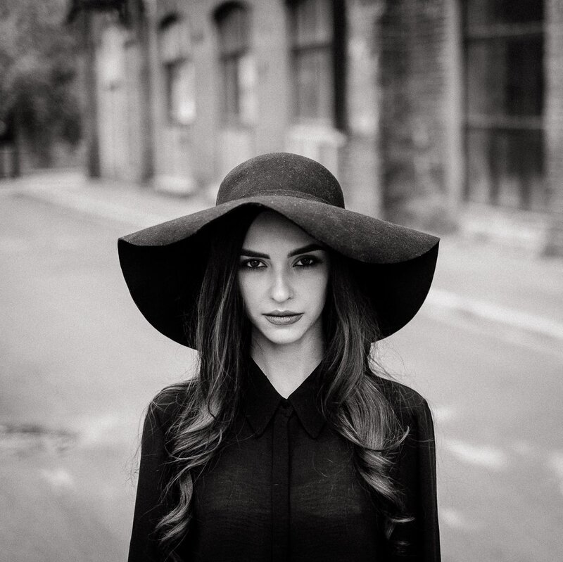 Woman in Wide-brimmed Hat — Black, Dramatic, Photograph, Building