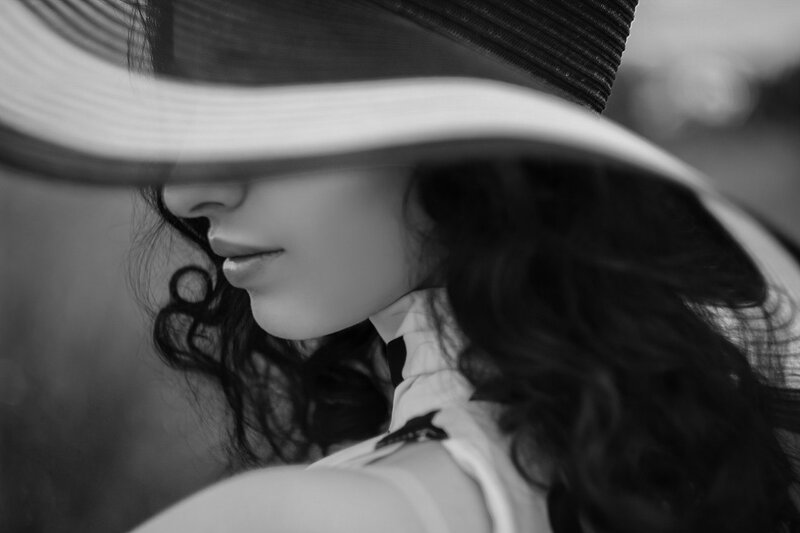 Woman in Wide-brimmed Hat — Black, Dramatic, Photograph, Curly Hair
