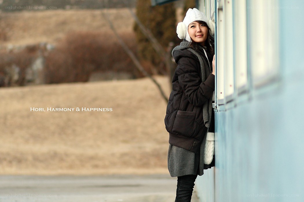 woman in winter clothes by train