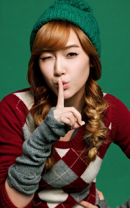 woman in winter clothes making shush gesture