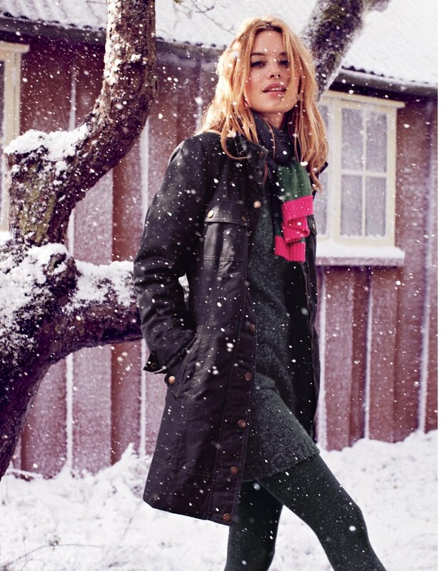 Woman in winter coat during snowfall