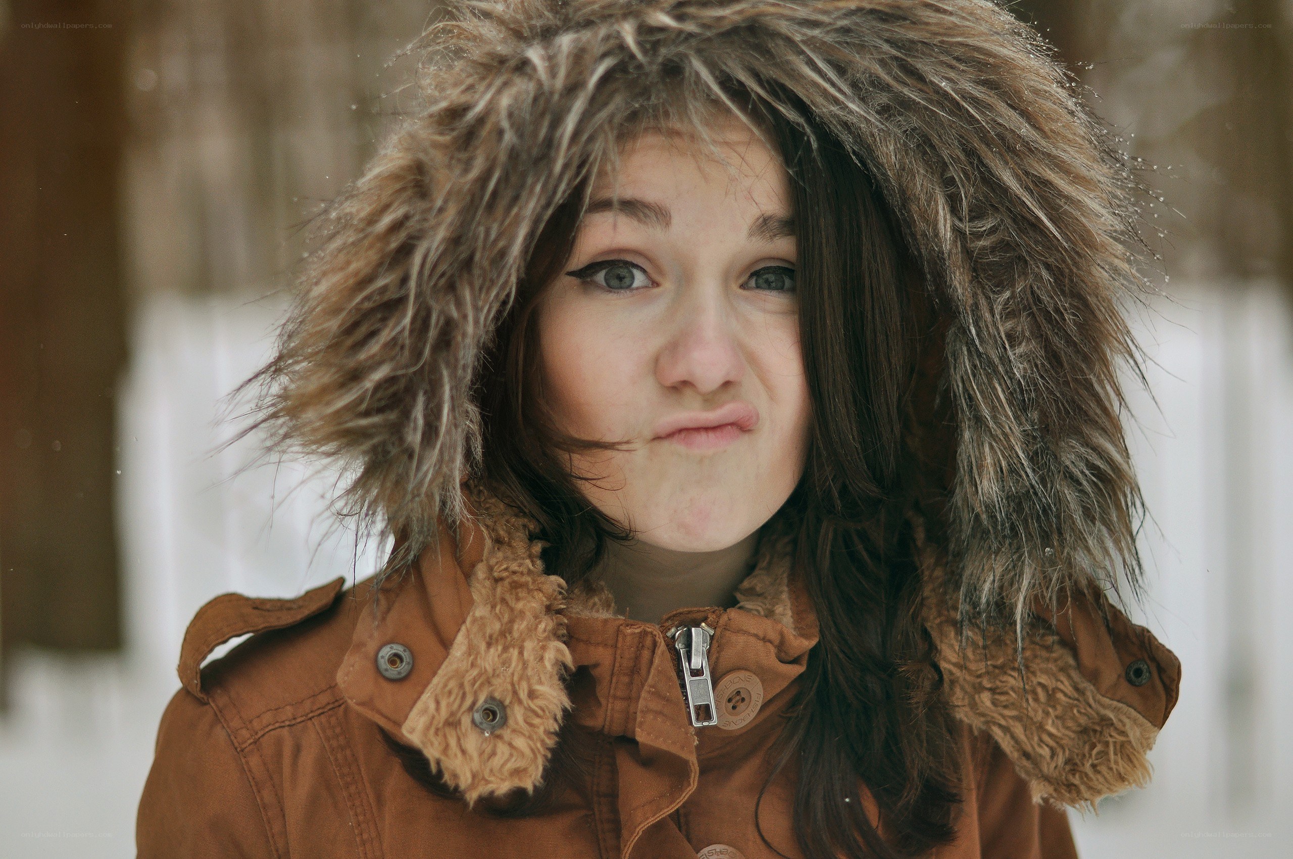 woman in winter coat making face