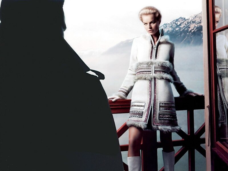 woman in winter coat on balcony