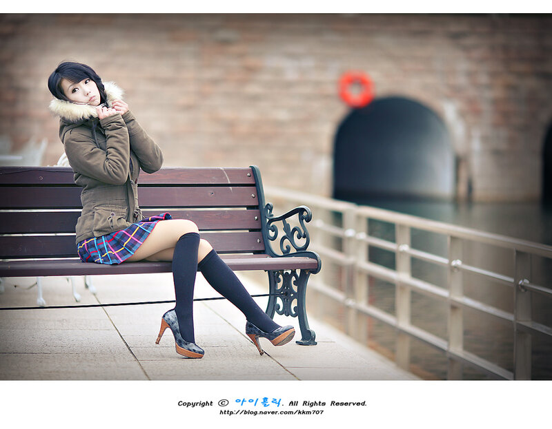 Woman in winter coat on bench