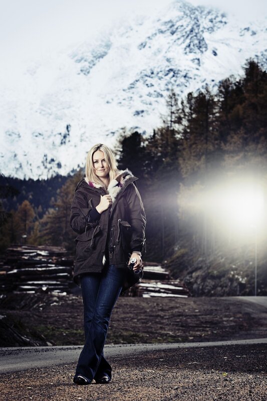 Woman in winter coat on mountain road