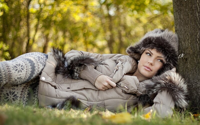 Woman in winter coat resting